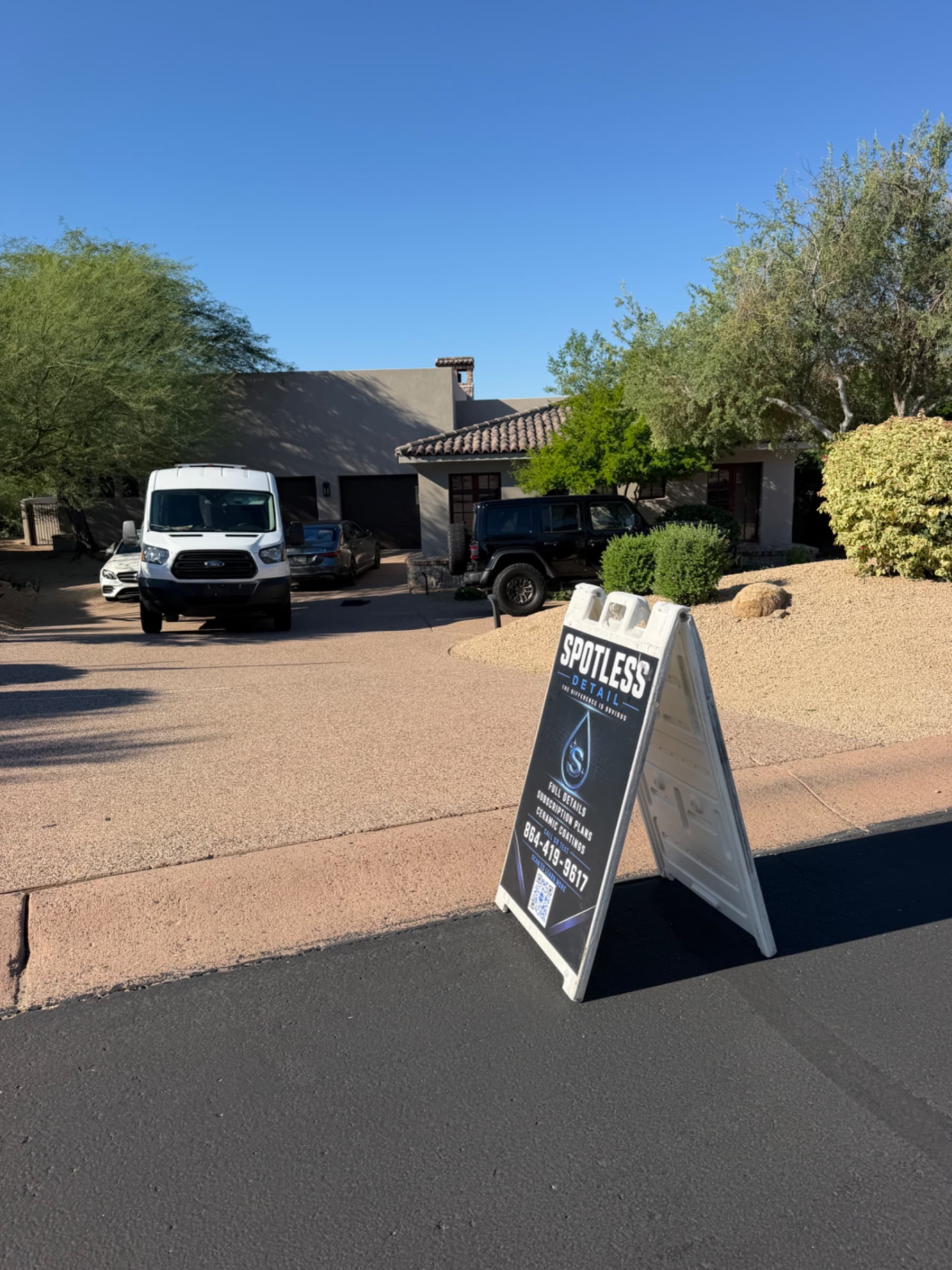Spotless Detail mobile detailing van and technician servicing a customer's car on-site in Scottsdale